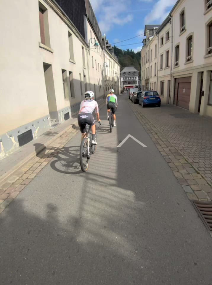 Cyclists riding along a narrow street in Belgium