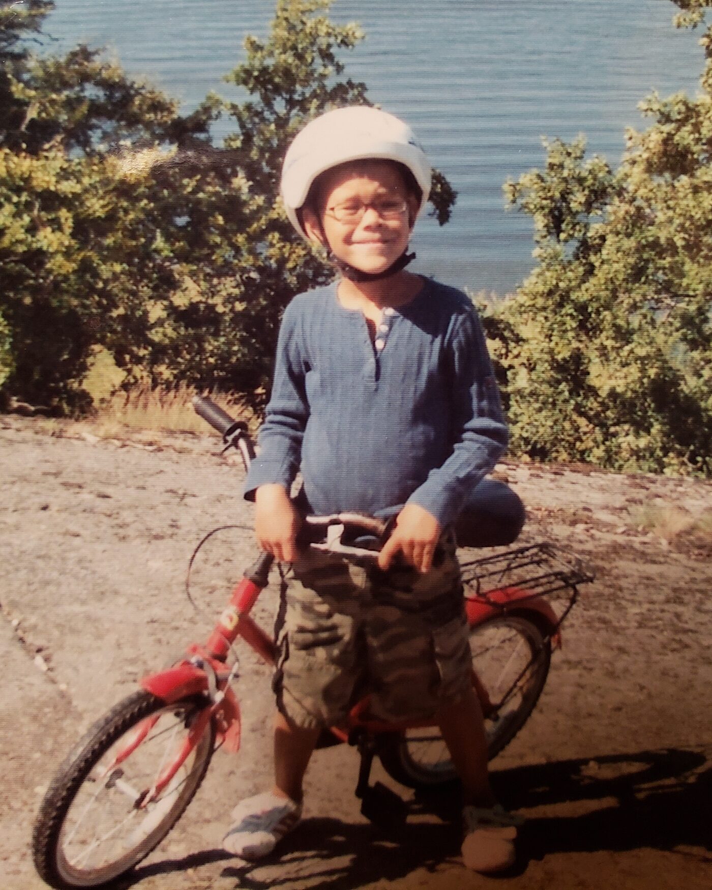 Donoven as a boy with his first bike beside a Swedish lake